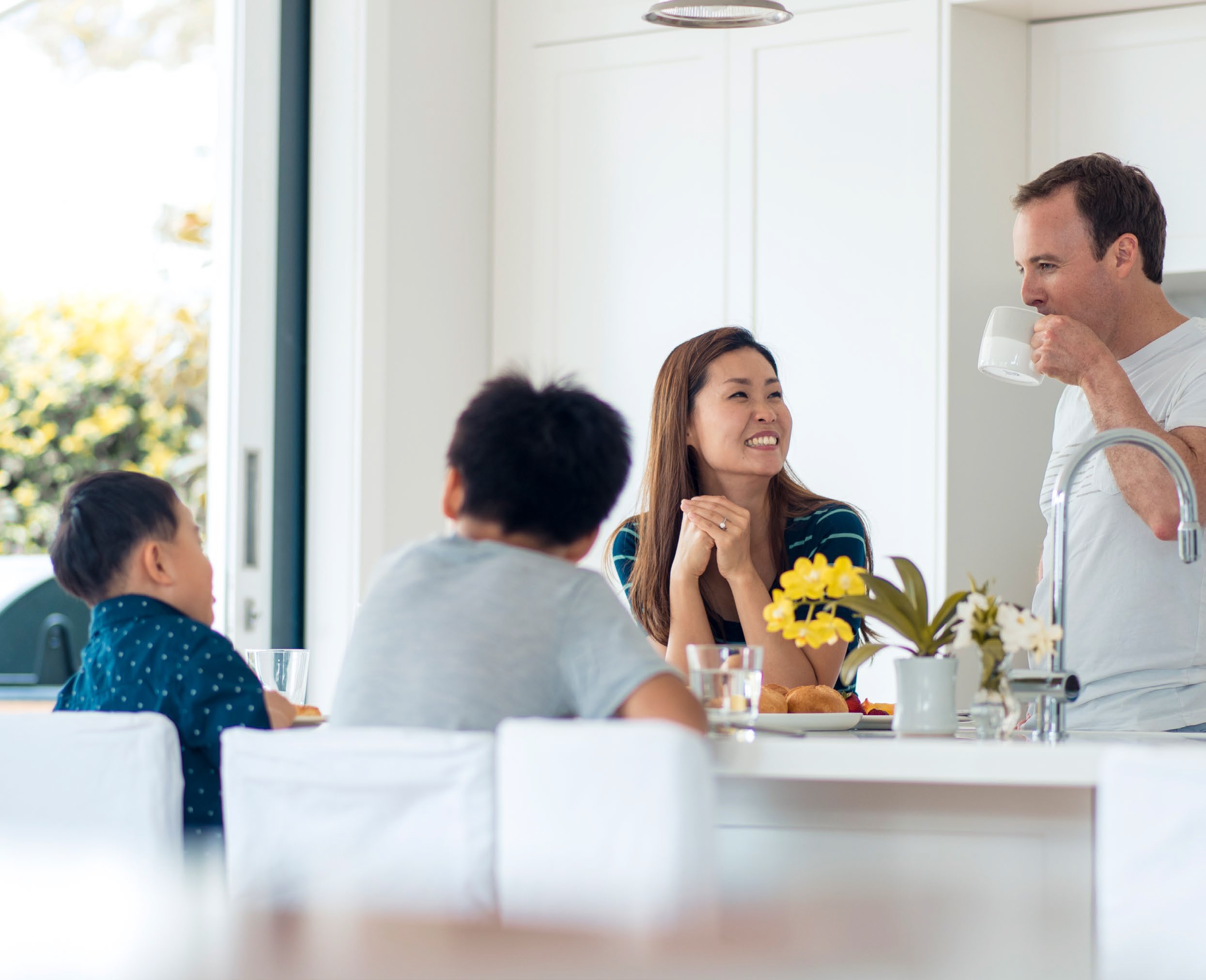 Photo of family around a breakfast bar at home